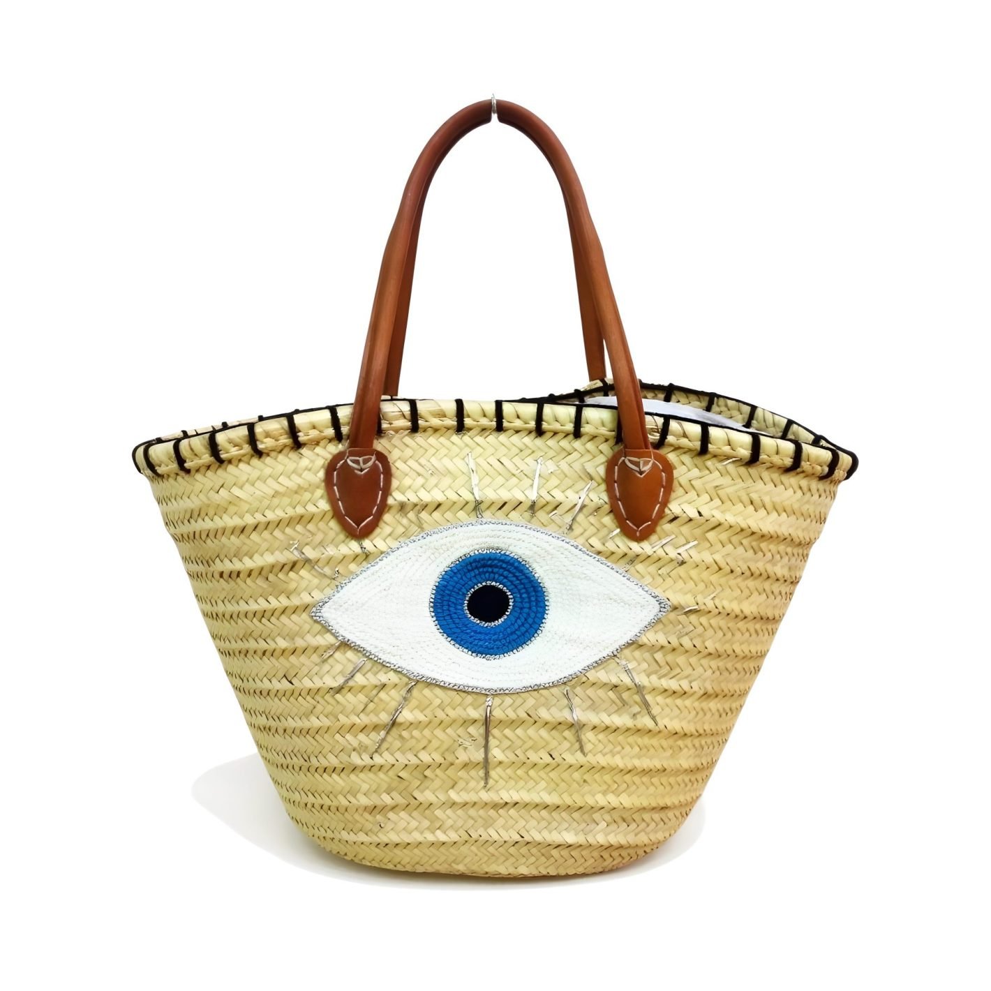 Unique Moroccan Straw Handbag Embroidered with Evil Eye Design (1) Woven straw beach bag with embroidered evil eye design and brown leather handles on white background