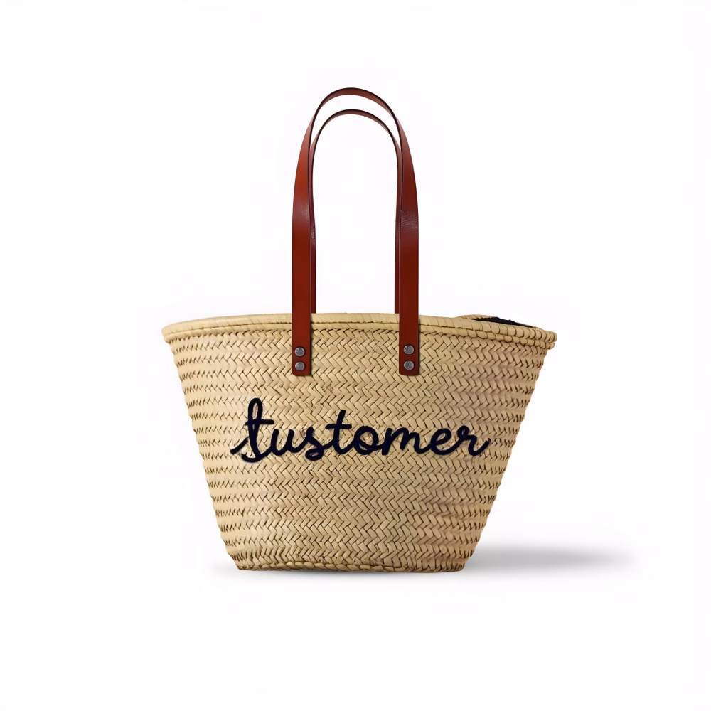 Personalized beach basket with 'customer' embroidered text on natural straw