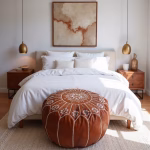 Embroidered ottoman leather pouf in modern bedroom setting