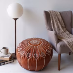 Handcrafted leather ottoman pouf with floor lamp