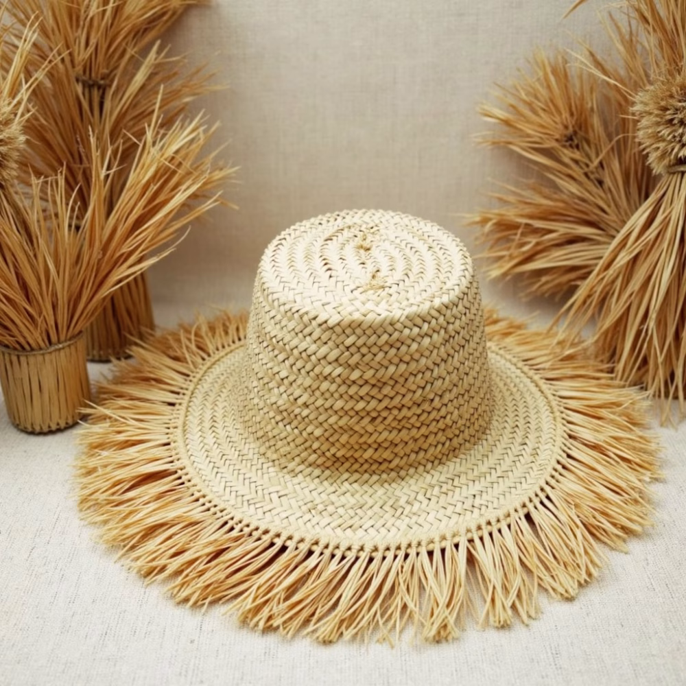 Flat lay of woven garden hat showing fringe details