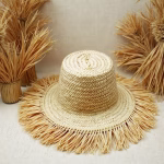 Flat lay of woven garden hat showing fringe details