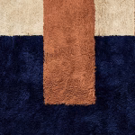 Close-up detail of boho wool rug showing plush texture in navy blue and terracotta