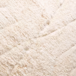 Close-up detail of plush ivory wool texture in handwoven Moroccan rug