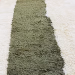 Close-up of green wool texture on handcrafted Moroccan boheme rug