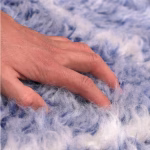 Close-up of soft wool texture on blue handcrafted farmhouse rug showing plush pile