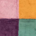Close-up of vibrant wool texture in multicolored Moroccan rug showing color transitions