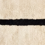 Close-up texture of handspun wool on traditional Moroccan Beni Ourain rug