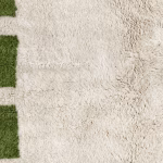 Close-up texture of plush wool pile on handmade Moroccan rug