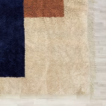 Corner detail of handwoven boho rug showing natural fringe and textural qualities