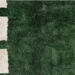 Detailed texture of emerald green wool pile on authentic Moroccan handwoven rug