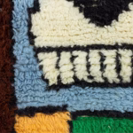 Detailed texture view of hand-knotted wool on traditional Berber rug
