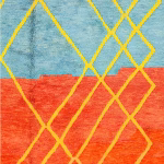 Detailed view of vibrant blue and orange wool with yellow geometric pattern on multicolor Moroccan rug