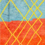 Detailed view of vibrant blue and orange wool with yellow geometric pattern on multicolor Moroccan rug