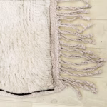 Hand-knotted fringe detail on artisanal Moroccan wool rug