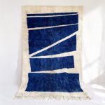 Handmade Moroccan Beni rug featuring contemporary geometric design in deep navy blue and cream