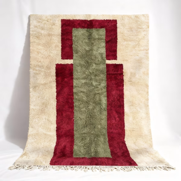Handmade Moroccan rug featuring burgundy frame with sage green center on cream background