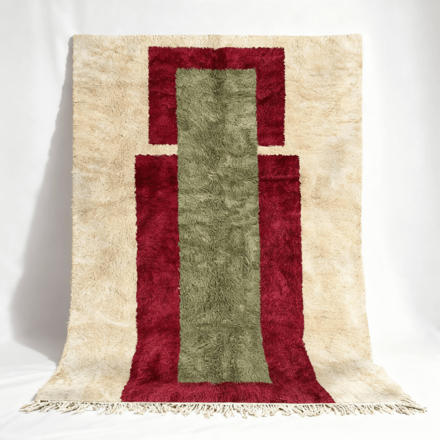 Handmade Moroccan rug featuring burgundy frame with sage green center on cream background Handmade Moroccan rug with burgundy and sage geometric design, cream border, traditional Berber wool craftsmanship