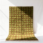 Green and brown handcrafted Moroccan trellis rug with geometric square motifs