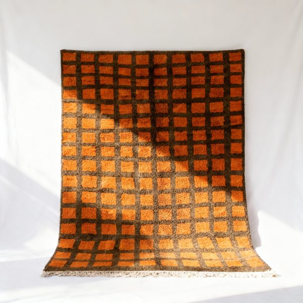 Handmade Moroccan trellis rug with vibrant orange squares on brown grid pattern