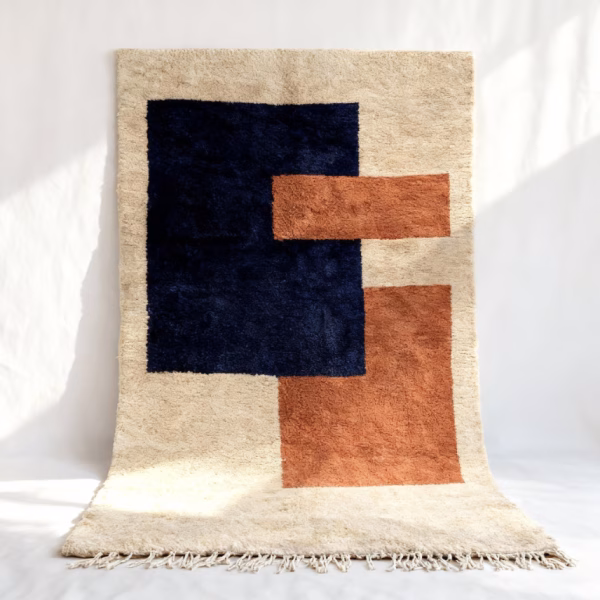 Handmade Moroccan wool boho rug featuring abstract design in navy blue, terracotta, and cream colors