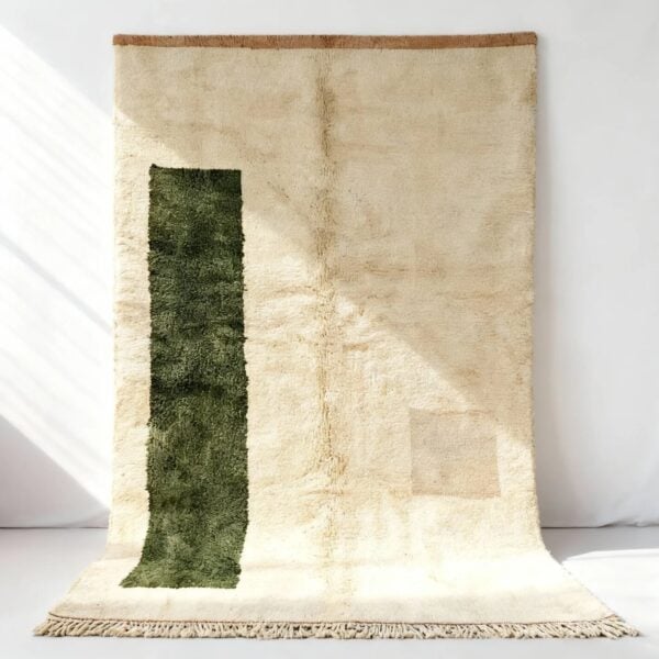 Handwoven Moroccan boheme rug in natural cream with vertical green accent stripe and textured wool pile