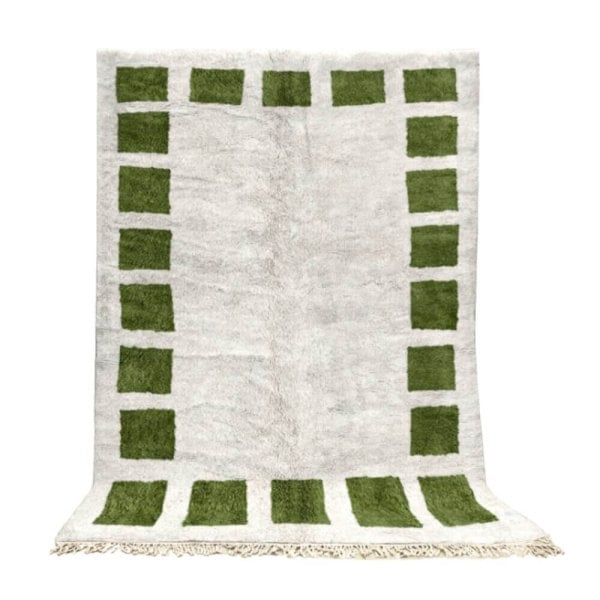 Moroccan rug in cream and green featuring geometric border squares, handwoven wool with fringe, full view on white background