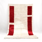 Handwoven Moroccan wool rug with vertical red rectangles and natural fringe