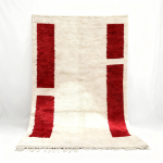 Handwoven Moroccan wool rug with vertical red rectangles and natural fringe
