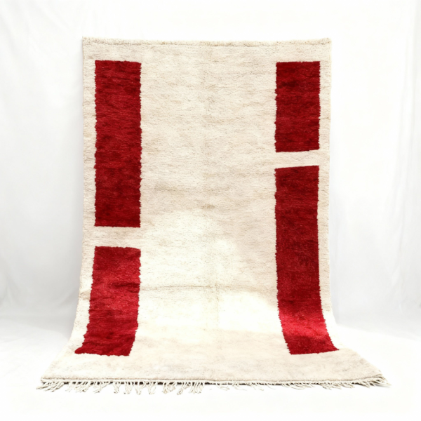 Handwoven Moroccan wool rug with vertical red rectangles and natural fringe