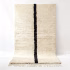 Handwoven traditional Moroccan rug with black single line on ivory wool