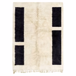 Moroccan minimalist rug with black geometric pattern on natural wool background