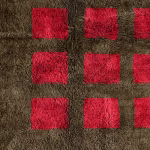 Natural wool texture detail of handmade Moroccan trellis rug with red checkerboard design