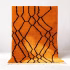 Vibrant orange Moroccan rug with black geometric pattern displayed in full view