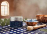 Blue nila powder jar displayed with copper bowl, brush on Moroccan tile for traditional hammam ritual