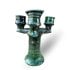 Green Tamegroute ceramic candlestick holder with triple arms and glossy glaze finish on white background