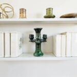 Artisan ceramic candlestick holder in emerald green with aqua undertones, side view showing triple holders