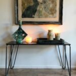 Green ceramic candlestick displayed on console table with candles, showing handcrafted diamond-shaped design