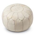 Handcrafted undyed genuine leather pouf in natural tan with embroidered geometric star motif on white studio background