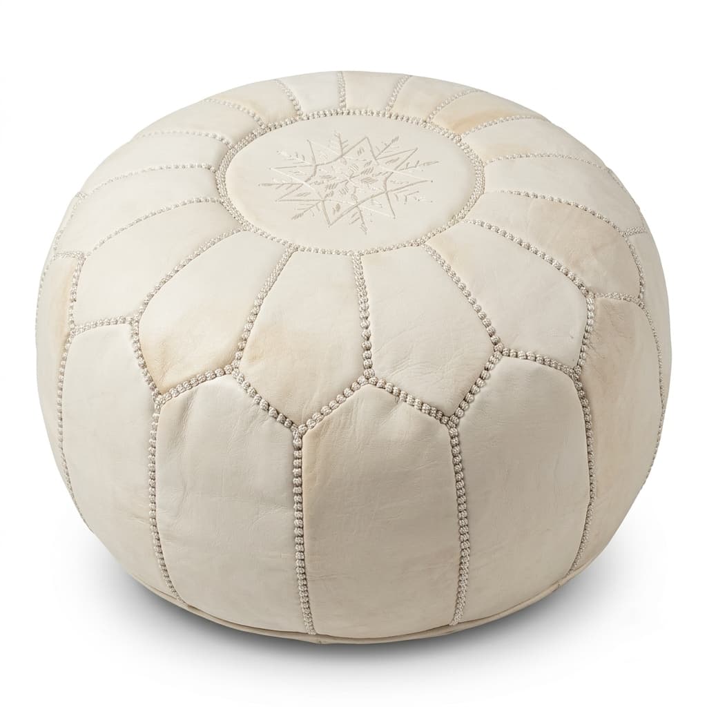 1 Handcrafted undyed genuine leather pouf in natural tan with embroidered geometric star motif on white studio background