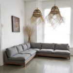 Handwoven straw pendant lights in bohemian living room with grey sectional sofa