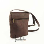 Back view of brown leather crossbody purse showing zippered pocket and adjustable strap