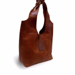 Side view of minimalist brown leather shoulder bag showing profile