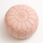 Handcrafted Moroccan pink pouf ottoman with starburst stitching pattern