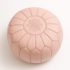 Handcrafted Moroccan pink pouf ottoman with starburst stitching pattern