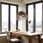 Dining space featuring woven boho lampshade