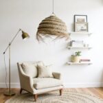 Handwoven straw chandelier with artisan frayed edge detail complementing natural fiber rug in bright interior