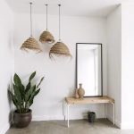 Pair of straw chandeliers creating balanced lighting in minimalist vanity area