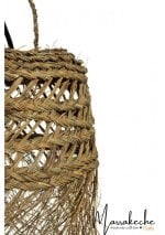 Close-up detail of handwoven straw pendant light showing intricate diagonal weave pattern and frayed edges