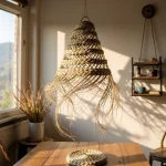 Single handwoven straw pendant light with natural fiber fringe beside woven floor cushion in cozy space